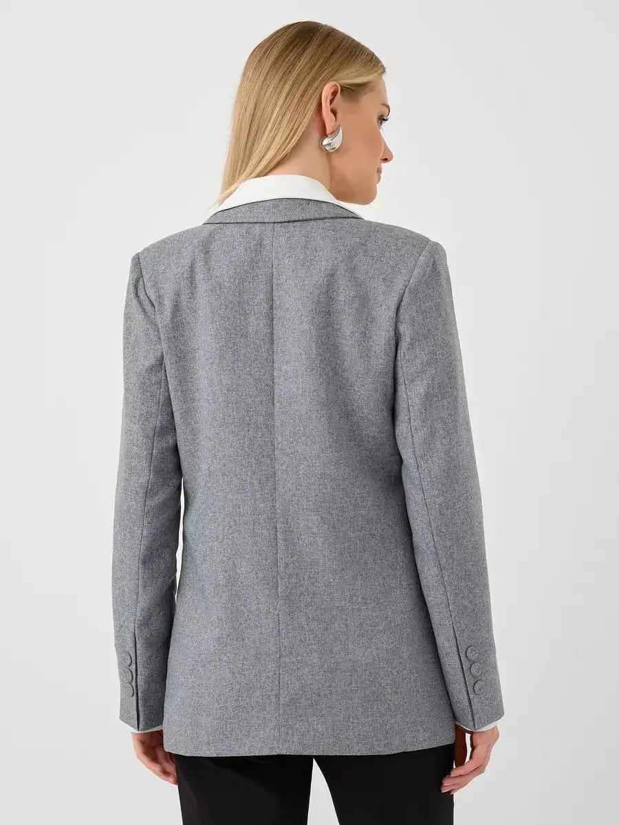 Back view of a woman wearing the Silverstone Blazer by Lauven, showcasing its elegant oversized gray design.