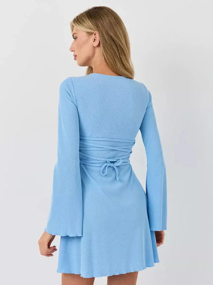 Back view of the Sky Belle pastel blue mini dress by Lauven, featuring a flared hem and long fluted sleeves.