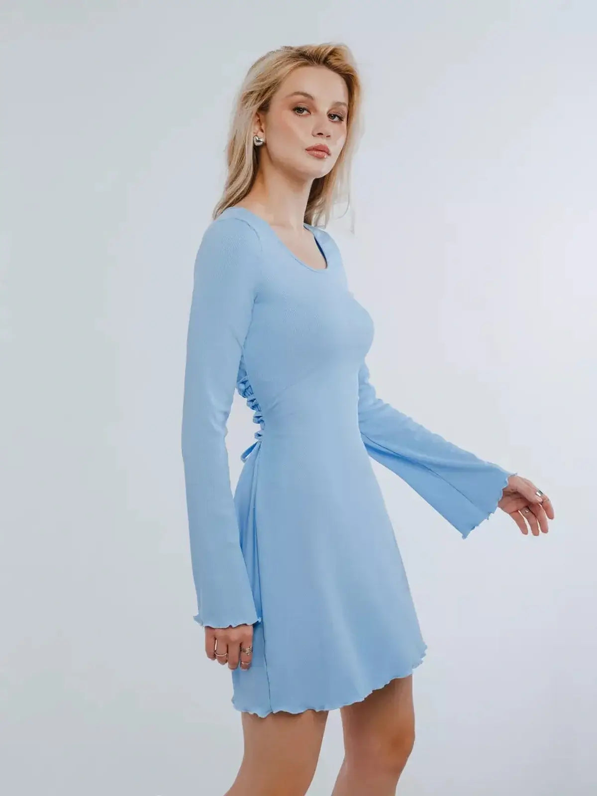 Light blue mini dress with long sleeves and lace-up back detailing, perfect for summer parties and special occasions.