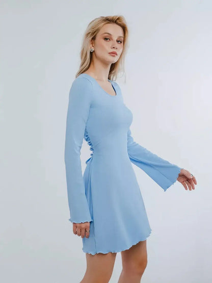 Light blue mini dress with long sleeves and lace-up back detailing, perfect for summer parties and special occasions.