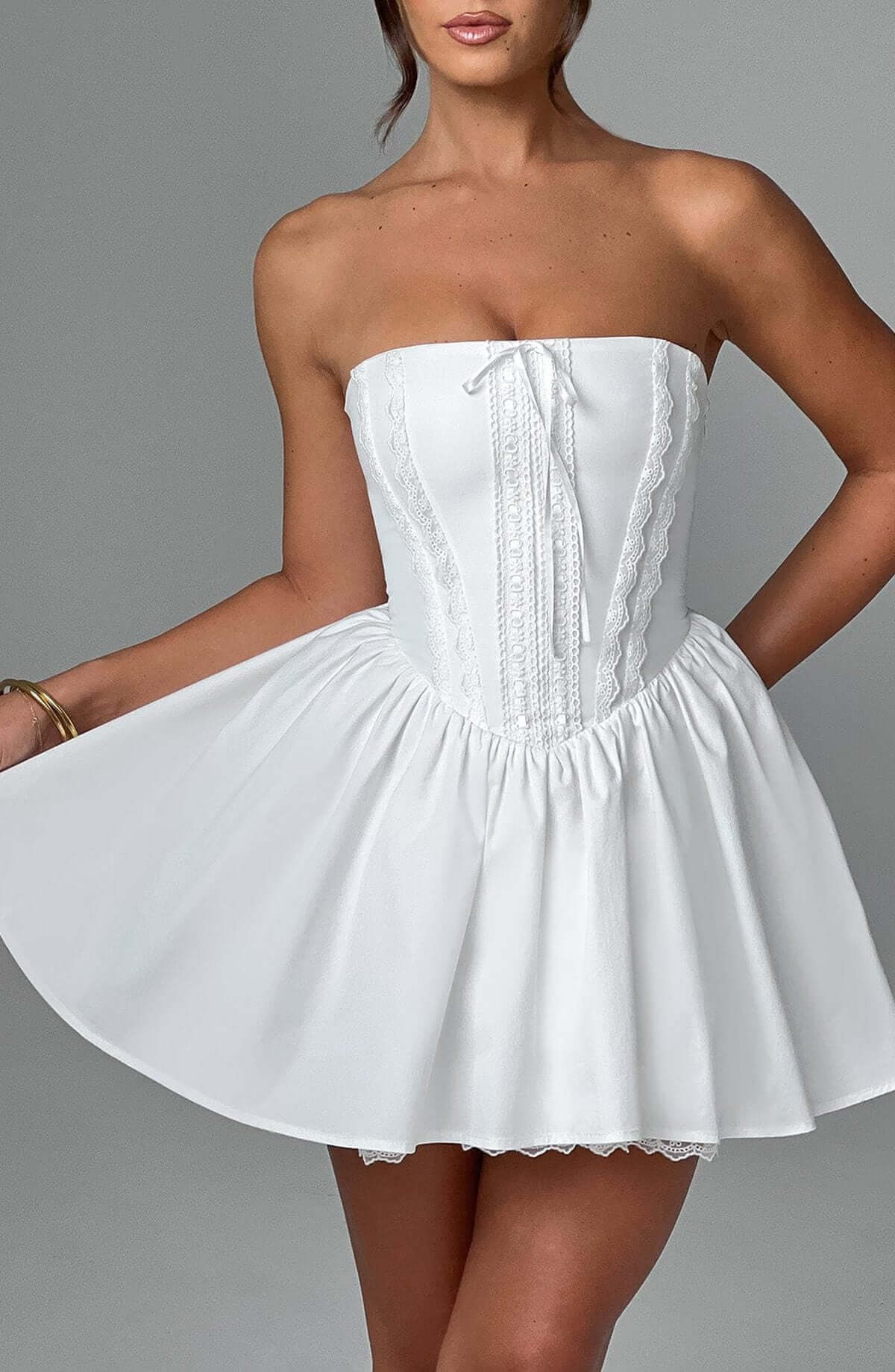 White strapless Skye Mini Dress featuring corset design and flowing skirt, perfect for summer parties or wedding guests.