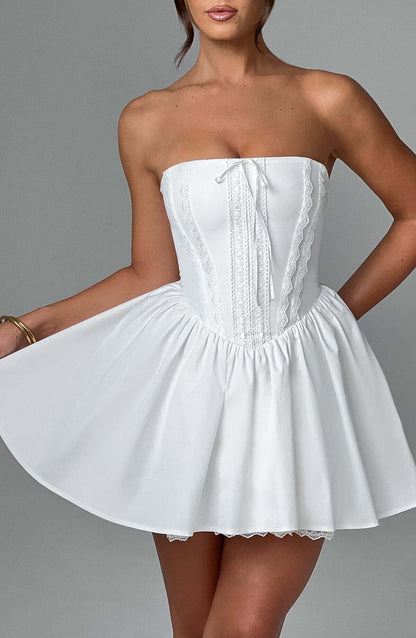 White strapless Skye Mini Dress featuring corset design and flowing skirt, perfect for summer parties or wedding guests.