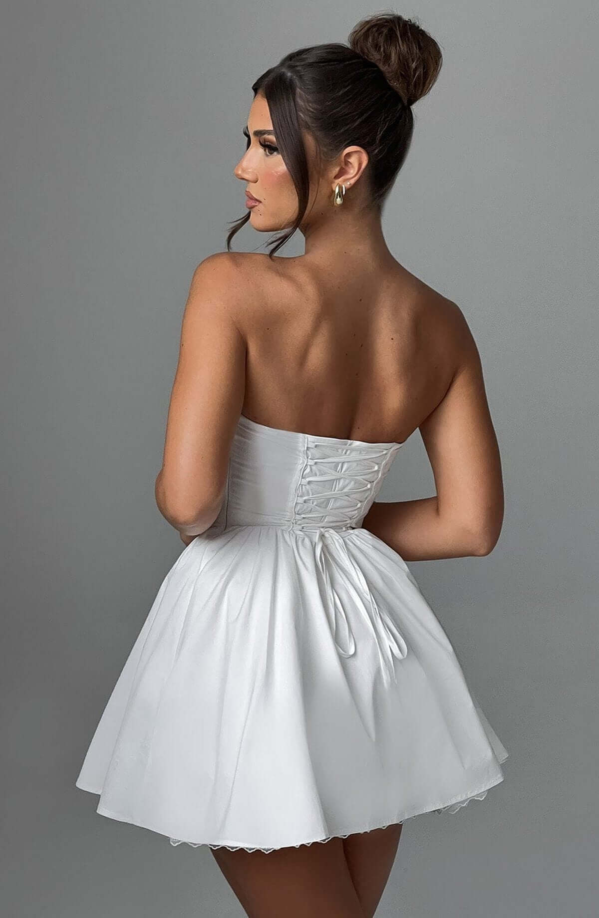 Back view of the Skye Mini Dress, a white corset mini dress for women, perfect for wedding guests and summer parties.