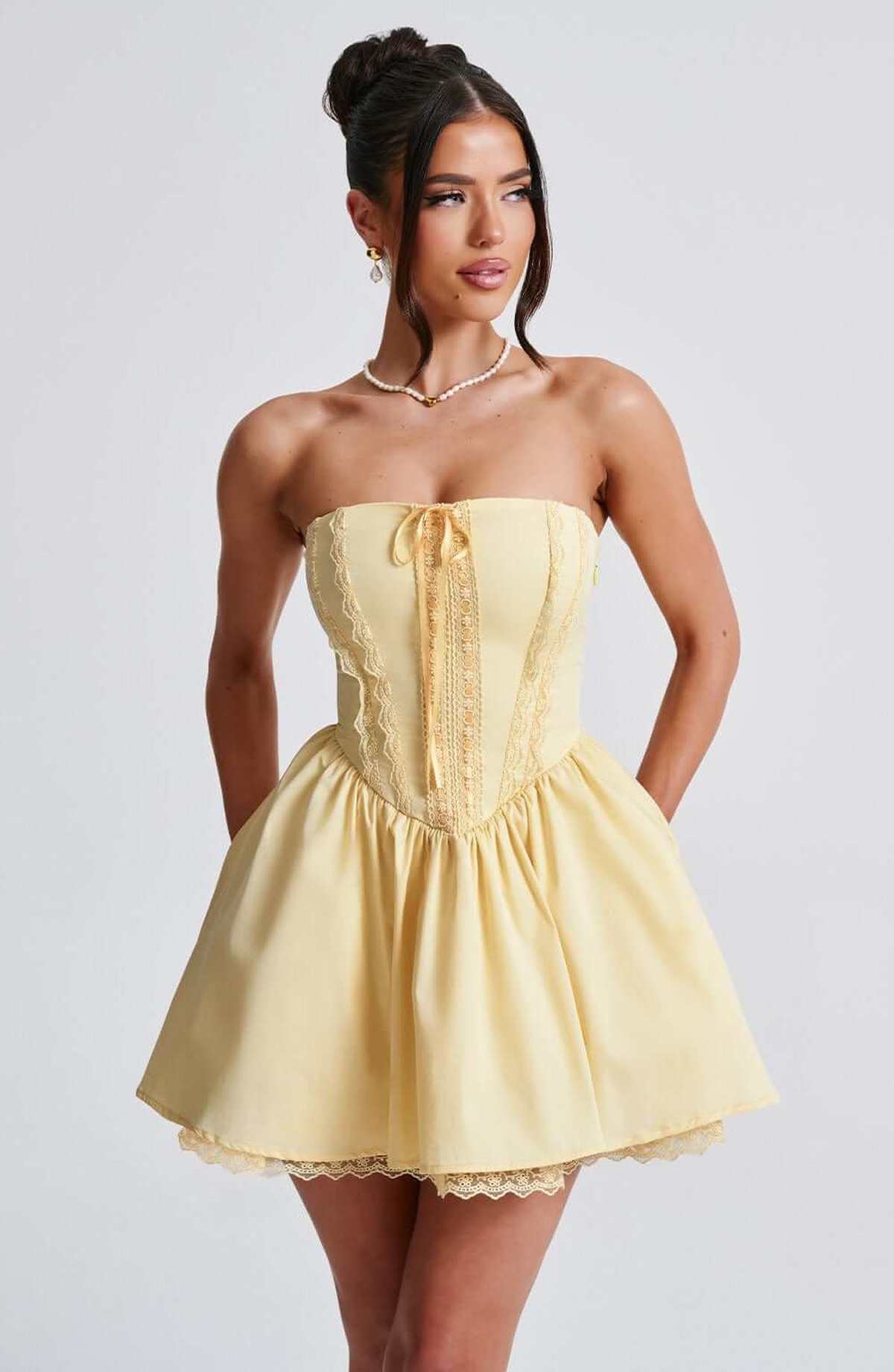 Skye Mini Dress featuring a strapless corset design in yellow, perfect for summer events and stylish occasions.