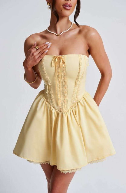 Stylish yellow Skye Mini Dress featuring a corset design and strapless neckline, perfect for summer parties or special occasions.