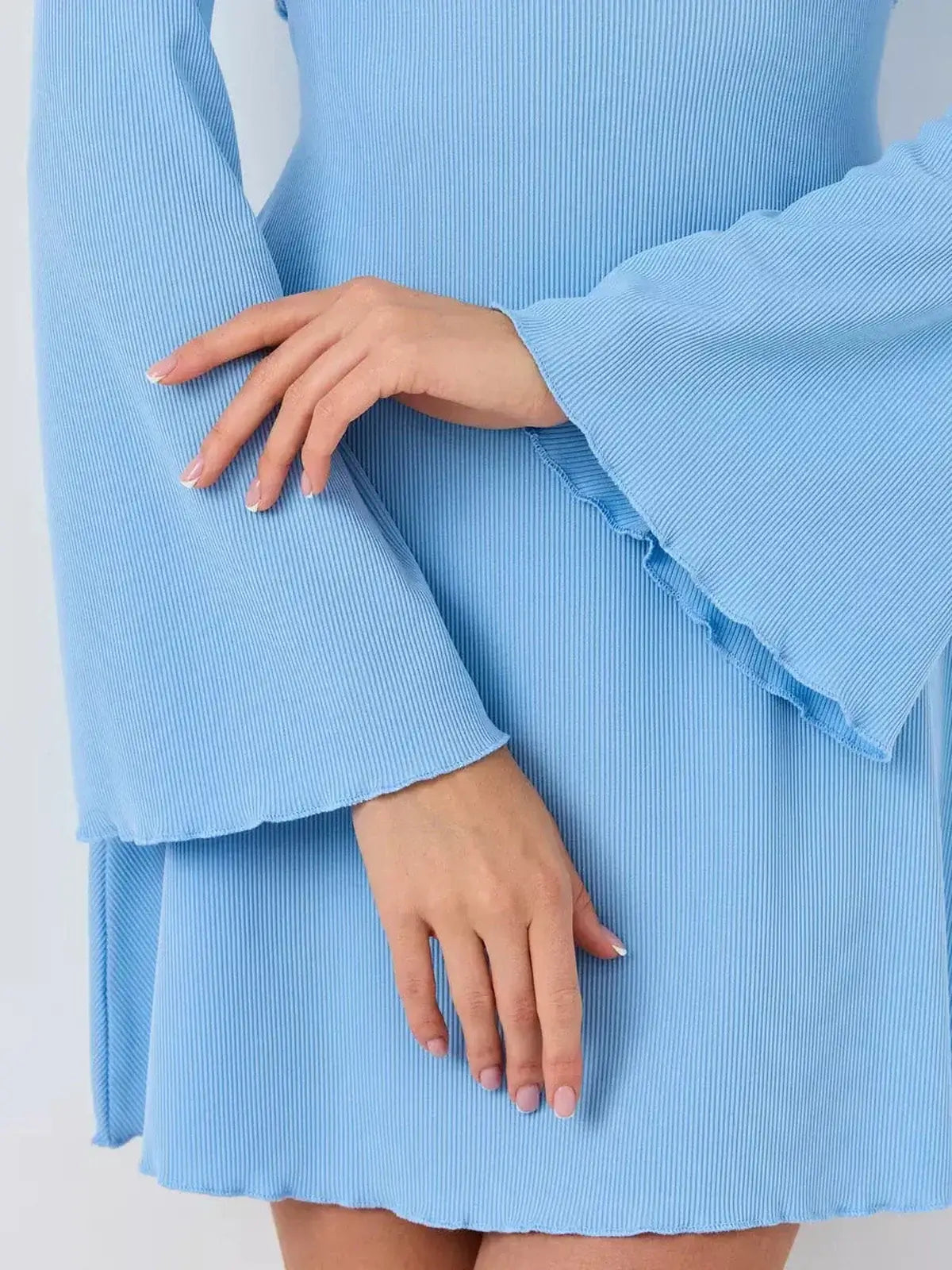 Close-up of flared sleeves and hands in a light blue Skyline Flare mini dress, perfect for summer and wedding guest occasions.