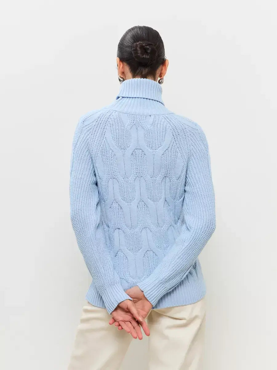 Skyline Knitwear by Lauven, showcasing a cozy pastel blue wool-blend turtleneck sweater with a cable-knit design.