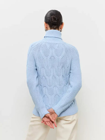 Skyline Knitwear by Lauven, showcasing a cozy pastel blue wool-blend turtleneck sweater with a cable-knit design.