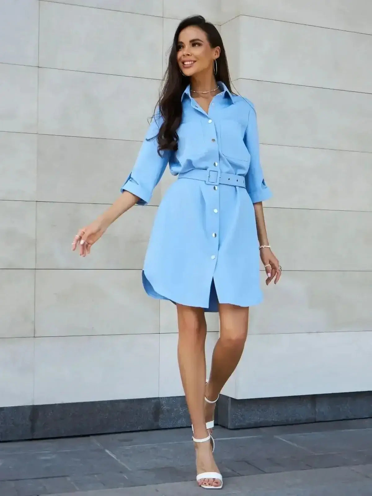Model wearing the Skyline Mini Dress by Lauven, a chic sky-blue shirt-inspired mini dress with rolled sleeves.
