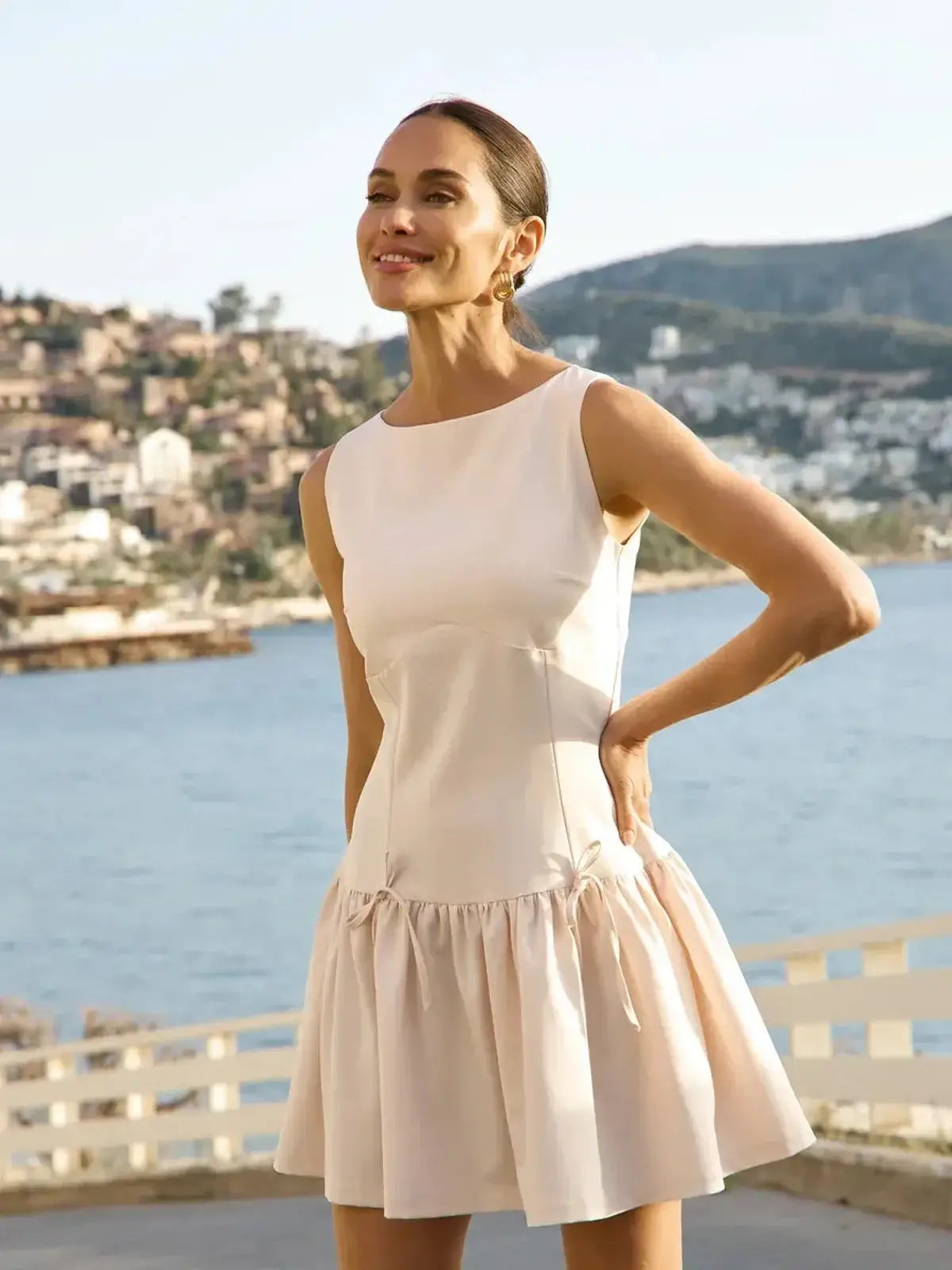 Model wearing a soft white midi dress with a flared skirt, perfect for summer and casual outings.