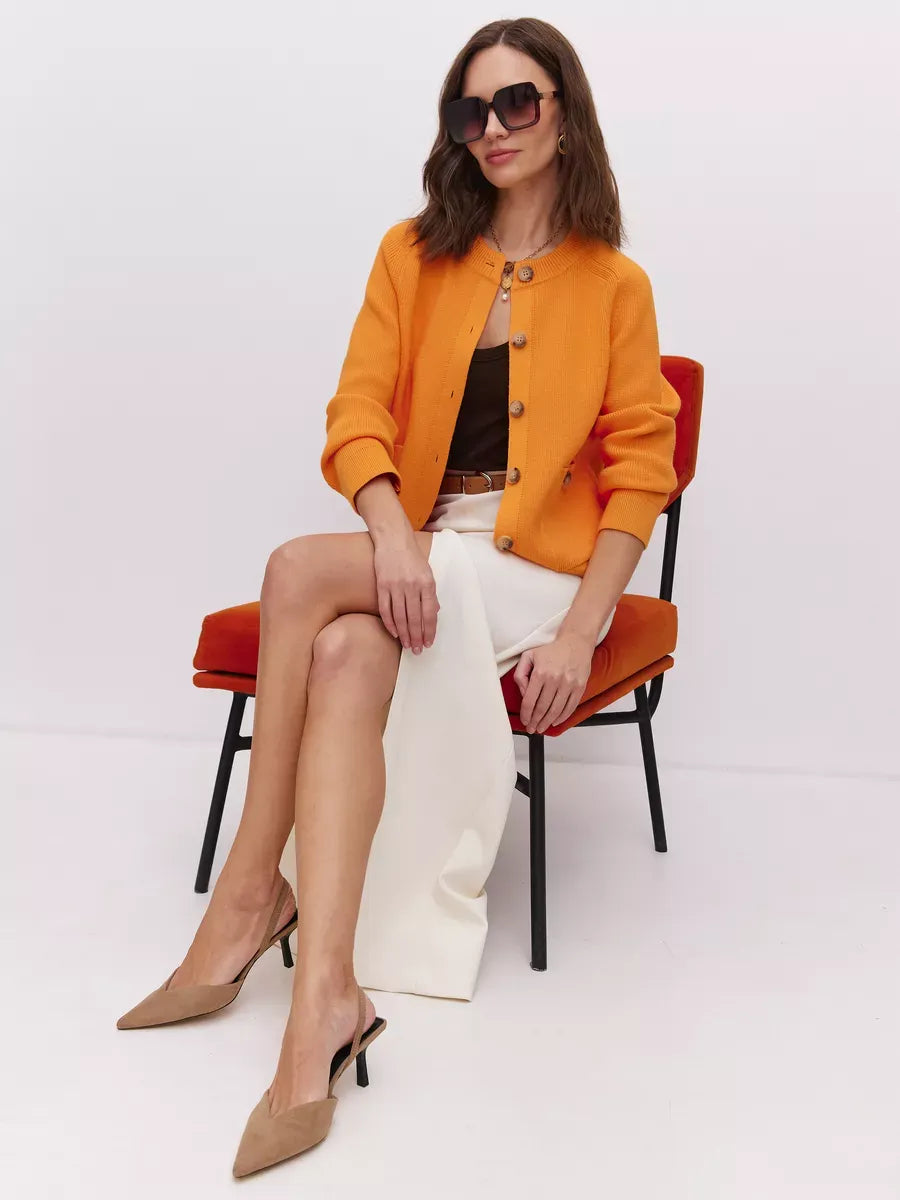 Solana Cardigan by Lauven in bold orange worn by a model, showcasing modern elegance and vibrant style.