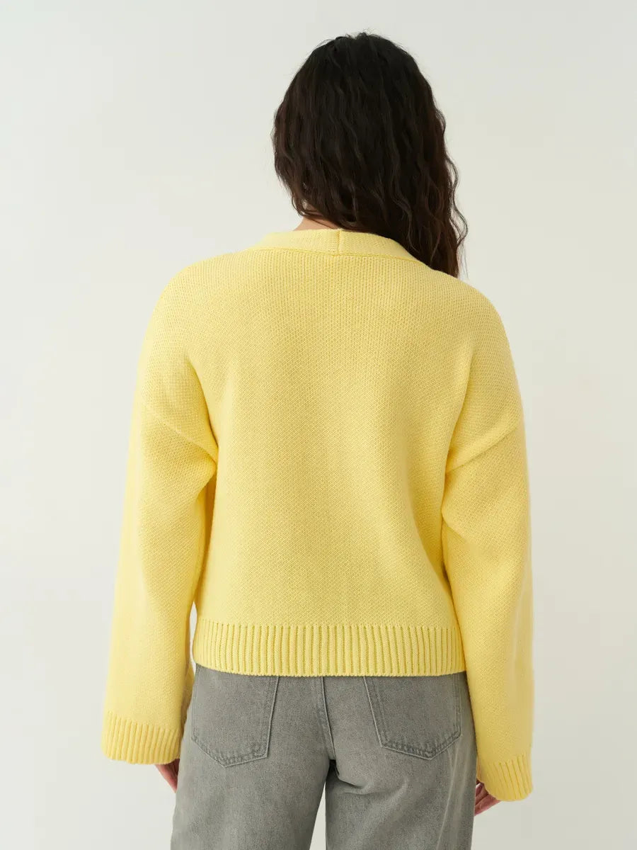 Back view of the Solara Cardigan by Lauven, a cropped yellow knitwear piece with a relaxed fit.