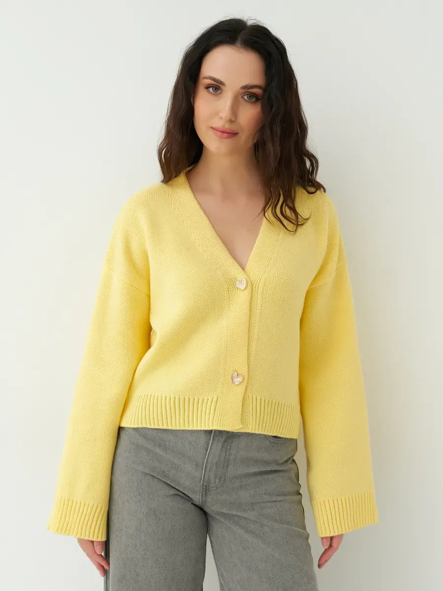Solara Cardigan by Lauven, cropped yellow knit sweater with heart buttons, perfect for elegant layering.