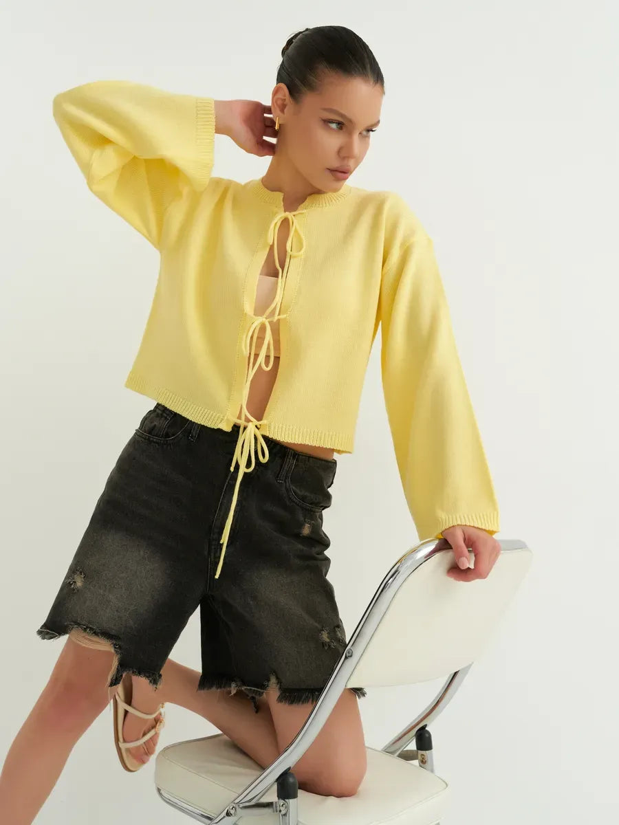 Cropped yellow knit Solara Cardigan by Lauven with tie-front detailing, ideal for summer layering.