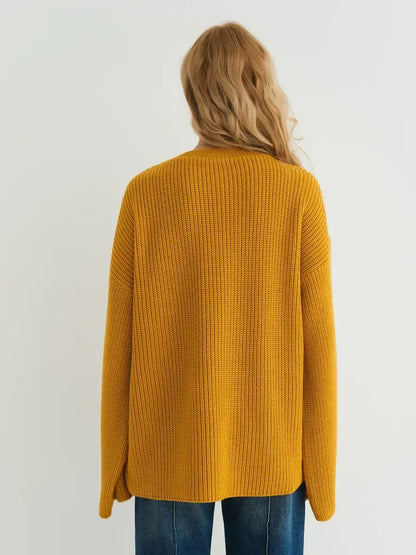 Back view of the oversized mustard yellow Solara Sweater by Lauven, showcasing ribbed knit texture.
