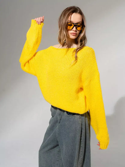 Model wearing the bright yellow Solara Sweater by Lauven, showcasing its oversized knit design and modern style.