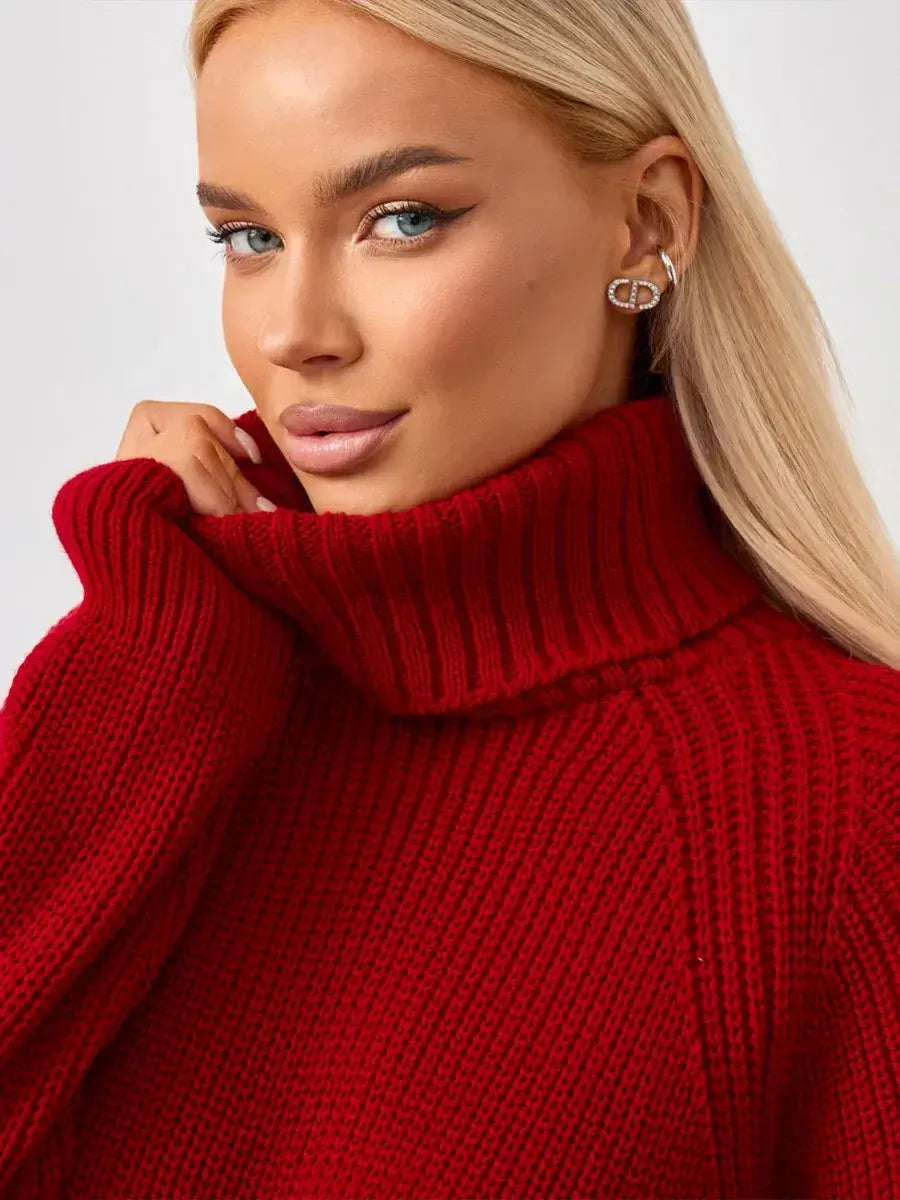 Model showcasing the Solara Sweater by Lauven, a cropped oversized knit with a bold turtleneck in a vibrant red.