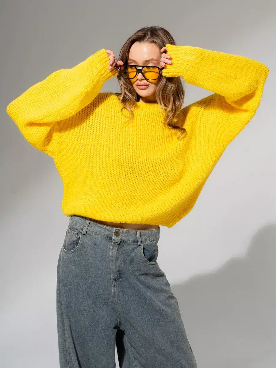 Model wearing an oversized bright yellow Solara Sweater by Lauven, showcasing its modern knit design.