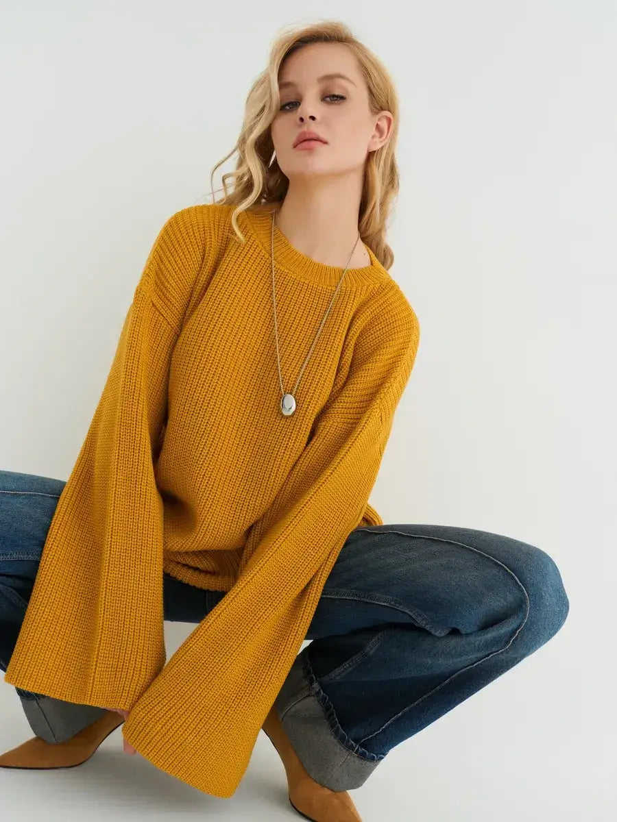 Model wearing the Solara Sweater by Lauven in mustard yellow, showcasing its oversized knit and stylish look.