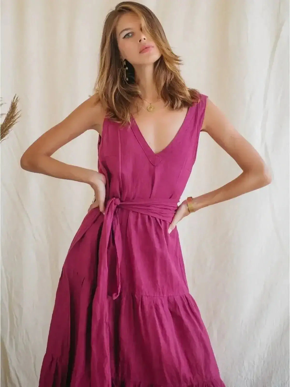 Elegant Solène Maxi Dress in vibrant pink linen, featuring a V-neckline and cinched waist for summer refinement.