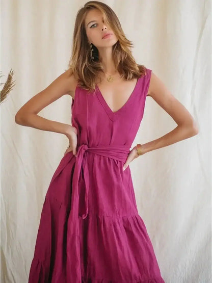 Elegant Solène Maxi Dress in vibrant pink linen, featuring a V-neckline and cinched waist for summer refinement.