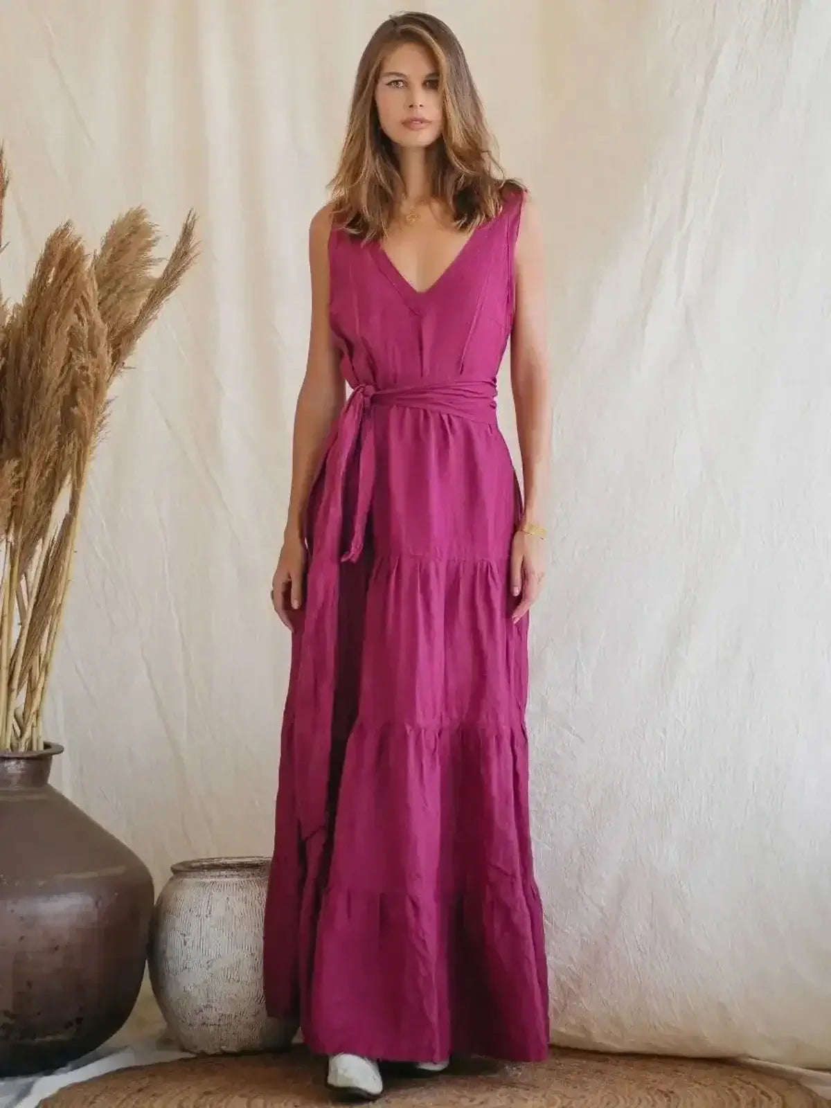Solène Maxi Dress in vibrant pink linen, featuring a V-neckline, tiered design, and cinched waist for summer elegance.