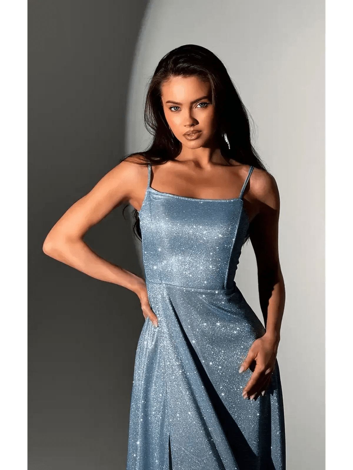 Model showcasing the Starlit Glow Maxi Dress in shimmer-blue with a glittering finish and elegant silhouette.
