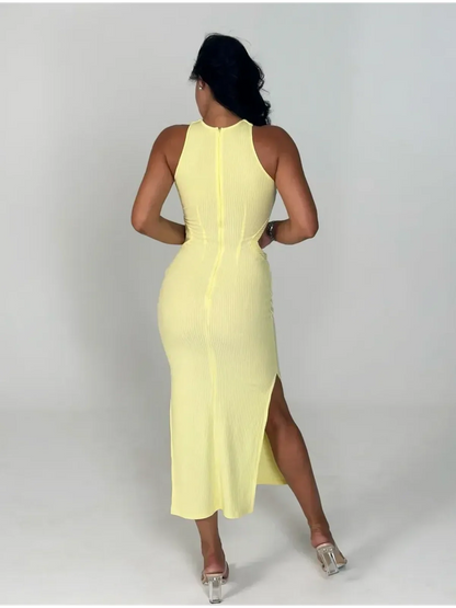 Back view of a woman in a yellow Sunlace Midi Dress featuring ribbed fabric and a thigh-high slit.