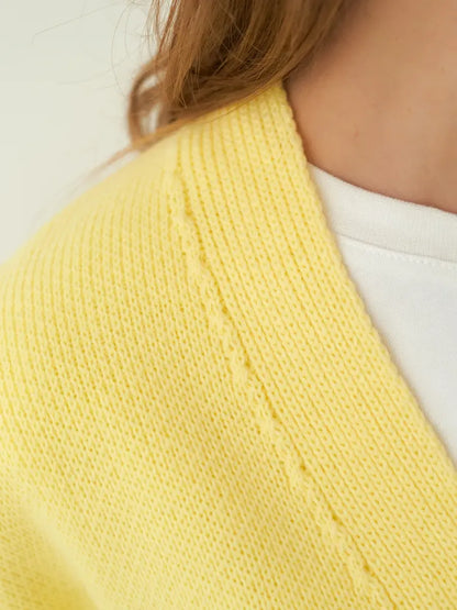Sunny Cardigan by Lauven – Close-up of soft yellow knitwear texture and detail.