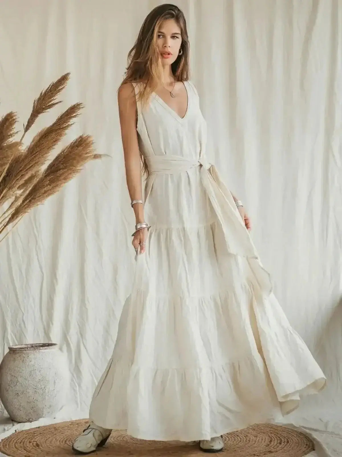 Suntrace Maxi Dress in lightweight linen, featuring a V-neckline, belted waist, and tiered hem for summer elegance.