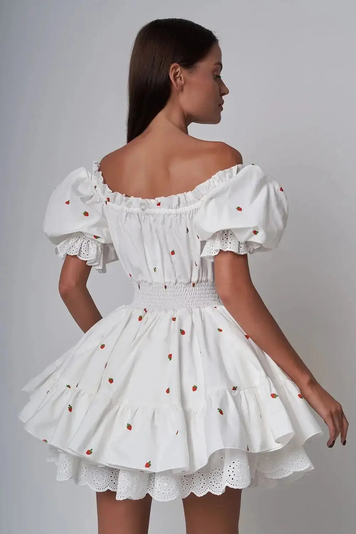 Thea Mini Dress with puff sleeves and ruffled skirt, perfect for summer weddings and parties.