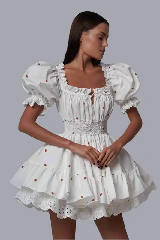 Thea Mini Dress featuring puff sleeves, a milkmaid neckline, and a playful flared silhouette, perfect for summer outings.