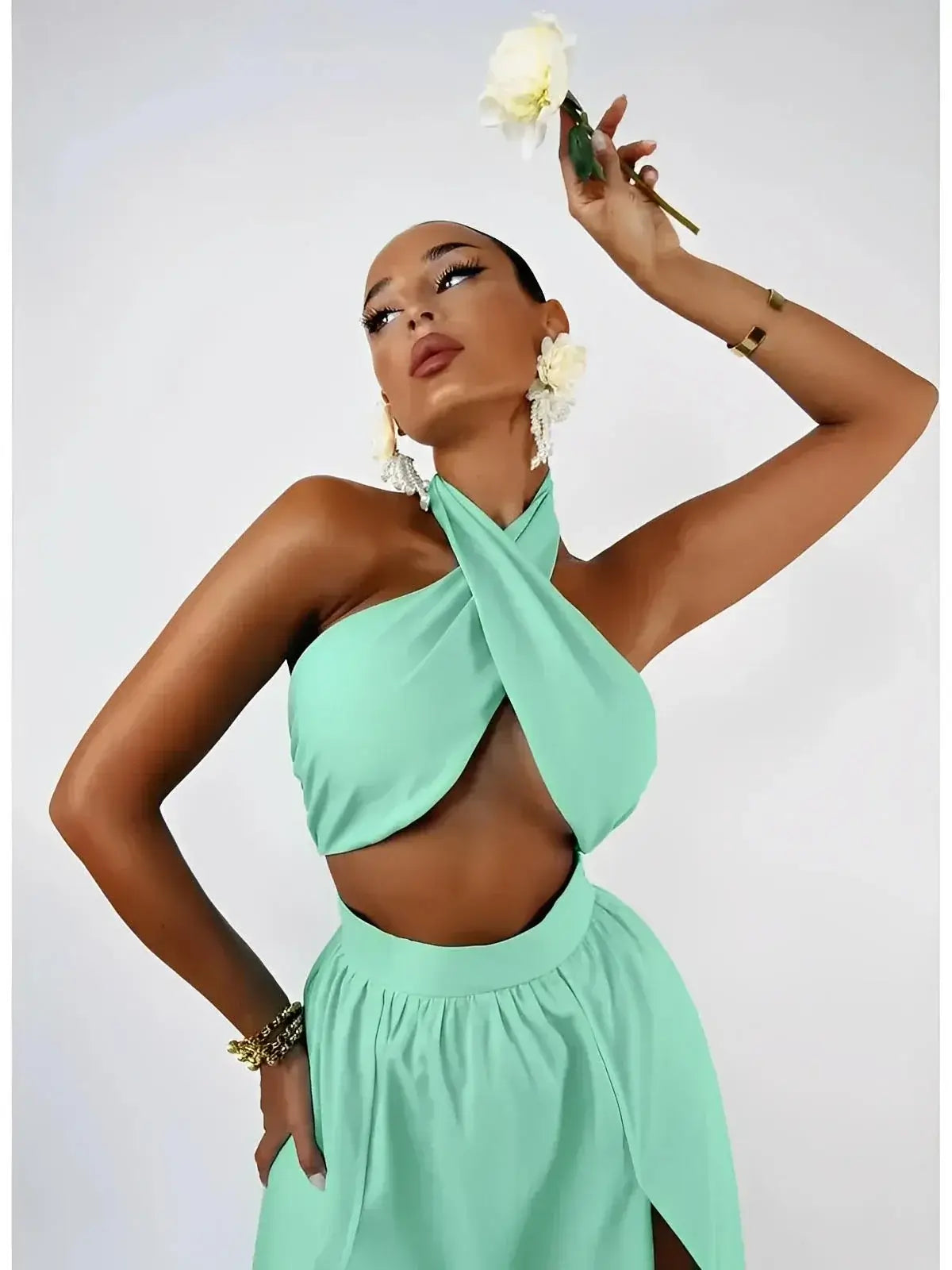 Model showcasing the Tiffany Breeze Set by Lauven, featuring a mint halter crop top and high-slit maxi skirt.