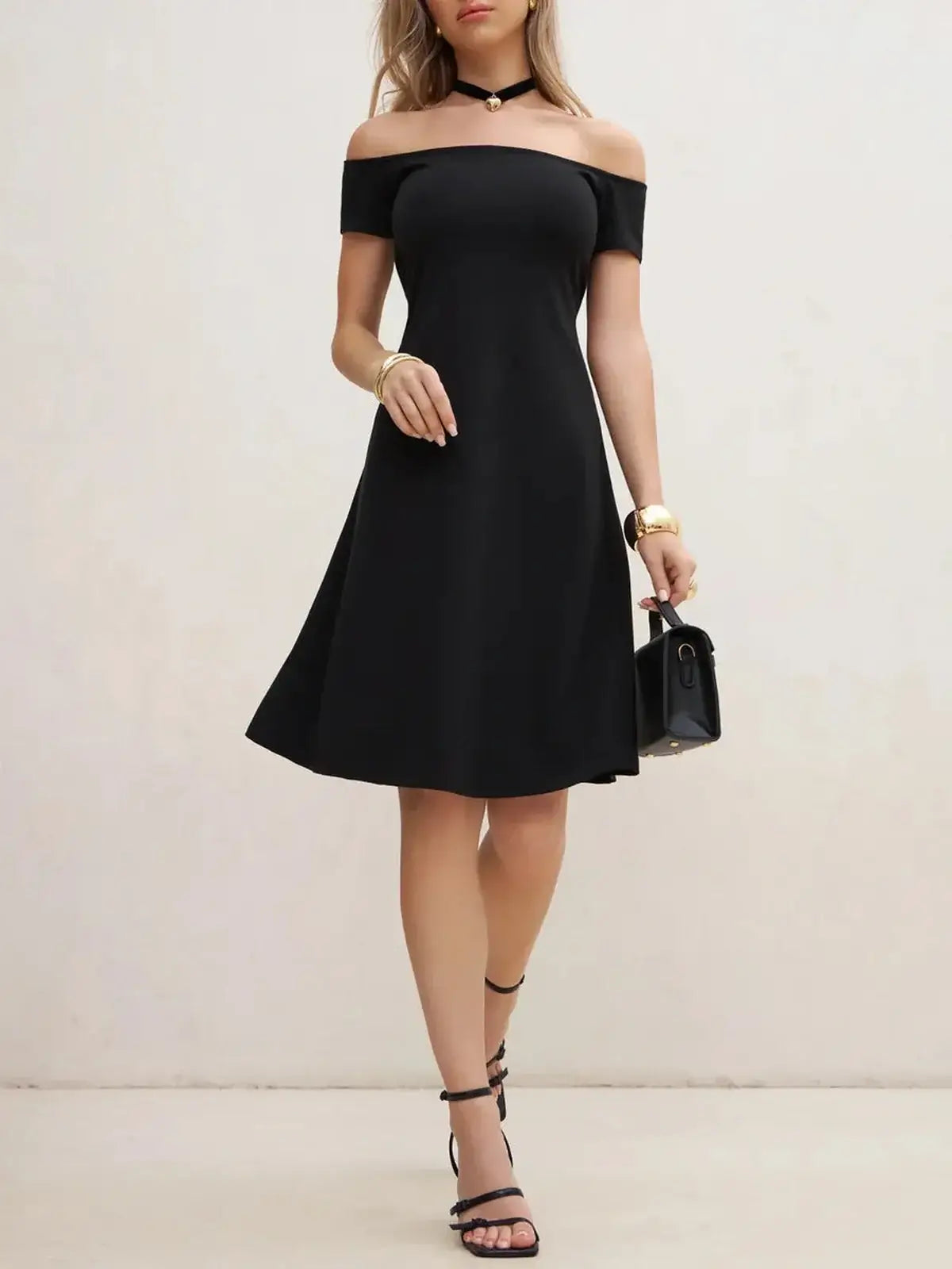 Elegant black off-shoulder mini dress featuring an A-line silhouette, perfect for party or wedding guest occasions.