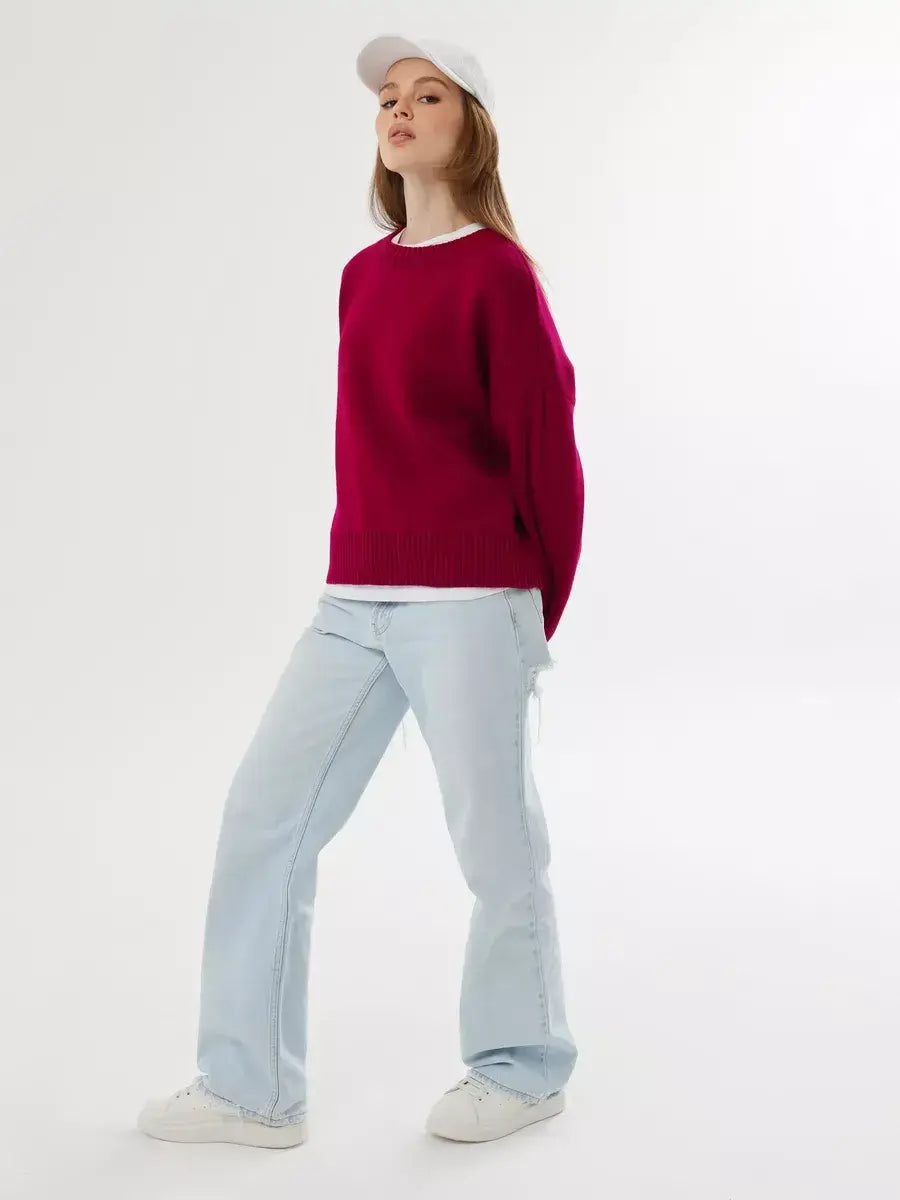 Vela Pullover by Lauven in vibrant burgundy, oversized cropped sweater, styled with light blue jeans.