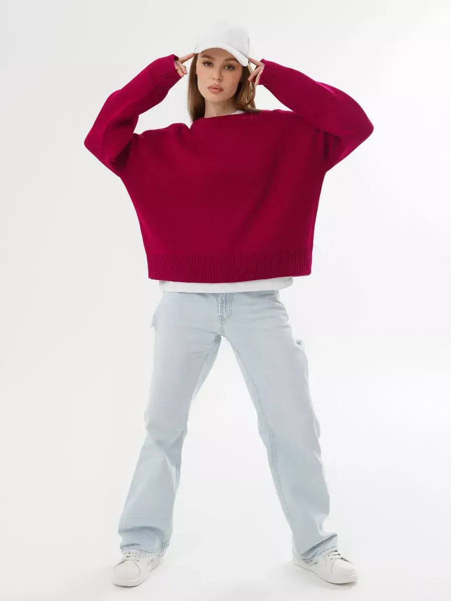 Vela Pullover by Lauven in burgundy, oversized cropped women's sweater paired with light denim and a white cap.