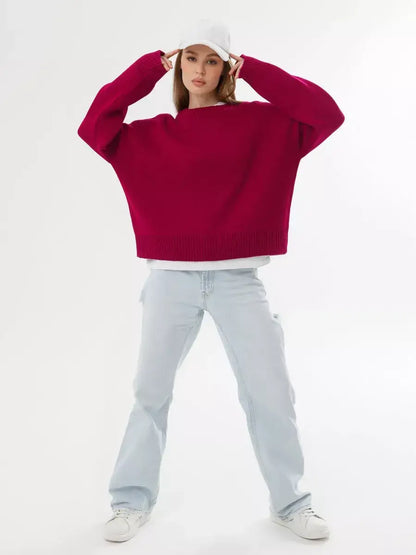 Vela Pullover by Lauven in burgundy, oversized cropped women's sweater paired with light denim and a white cap.