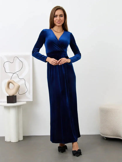Elegant woman in deep sapphire velour maxi dress with wrap bodice and V-neckline, perfect for formal occasions.