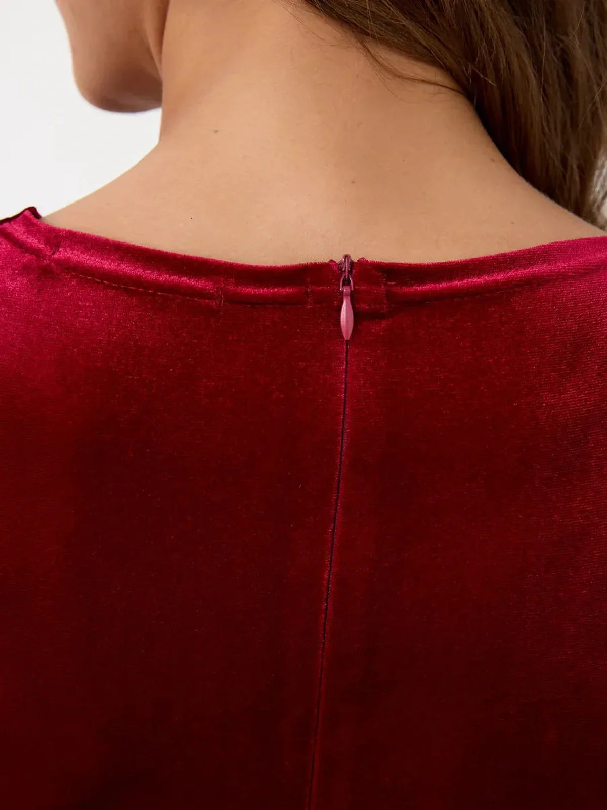 Close-up of the back neckline of the Velvet Allure Maxi Dress showcasing its elegant velvet texture and discreet zipper detail.