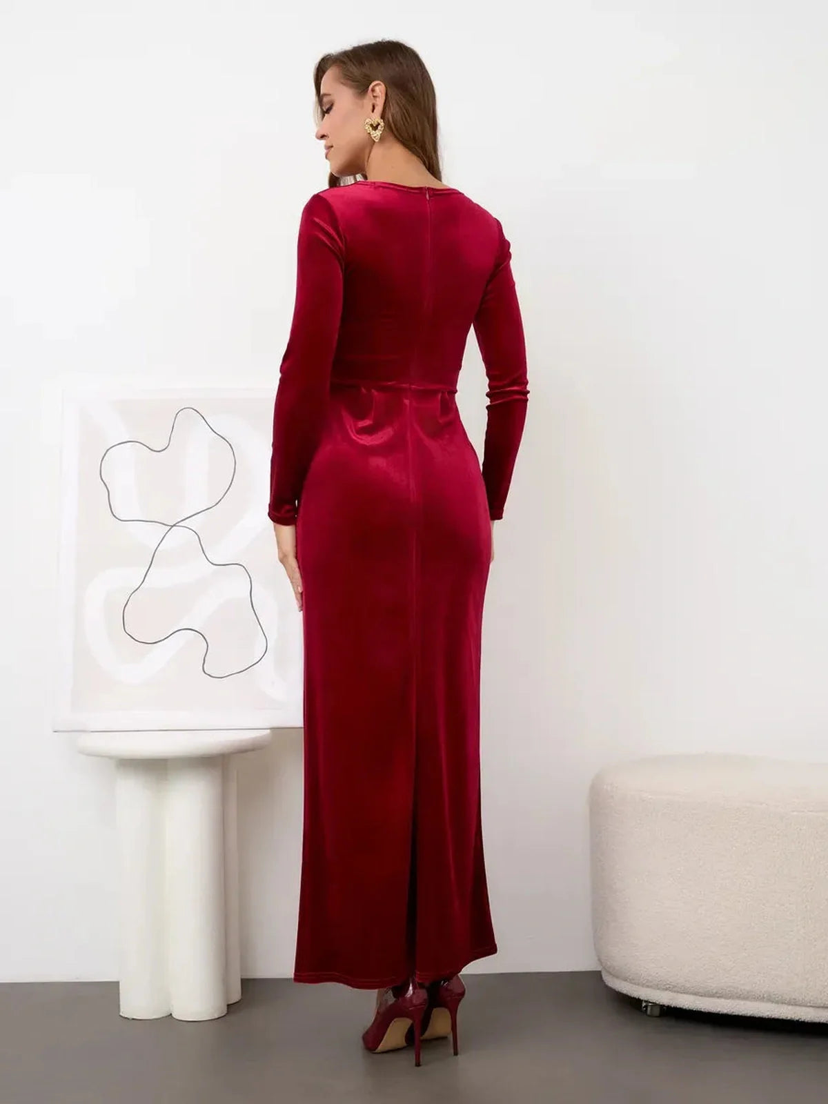 Back view of Velvet Allure Maxi Dress in deep wine red, featuring elegant draping and a thigh-high slit.