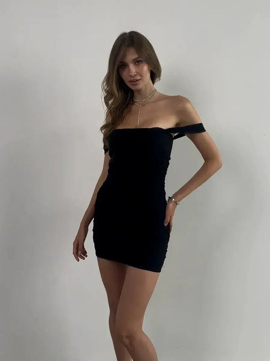 Velvet Curve off-shoulder black mini dress, perfect for summer nights, prom, and wedding guest occasions.