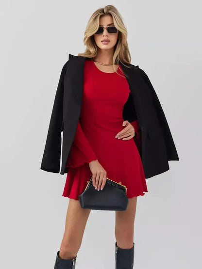 Model showcasing Velvet Flame red mini dress by Lauven with black outerwear and handbag.