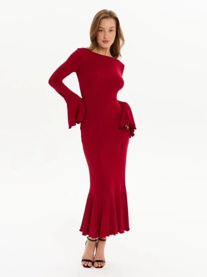Model wearing a red Velvet Flare long sleeve midi dress with flared cuffs and fishtail hem, perfect for formal occasions.