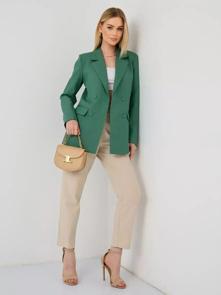 Woman wearing the Verde Blazer by Lauven, an oversized double-breasted green tailored jacket paired with stylish pants.