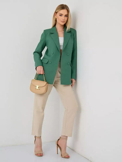 Woman wearing the Verde Blazer by Lauven, an oversized double-breasted green tailored jacket paired with stylish pants.