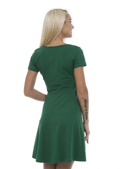 Back view of a woman wearing a green mini dress, showcasing its flattering silhouette and short sleeves.