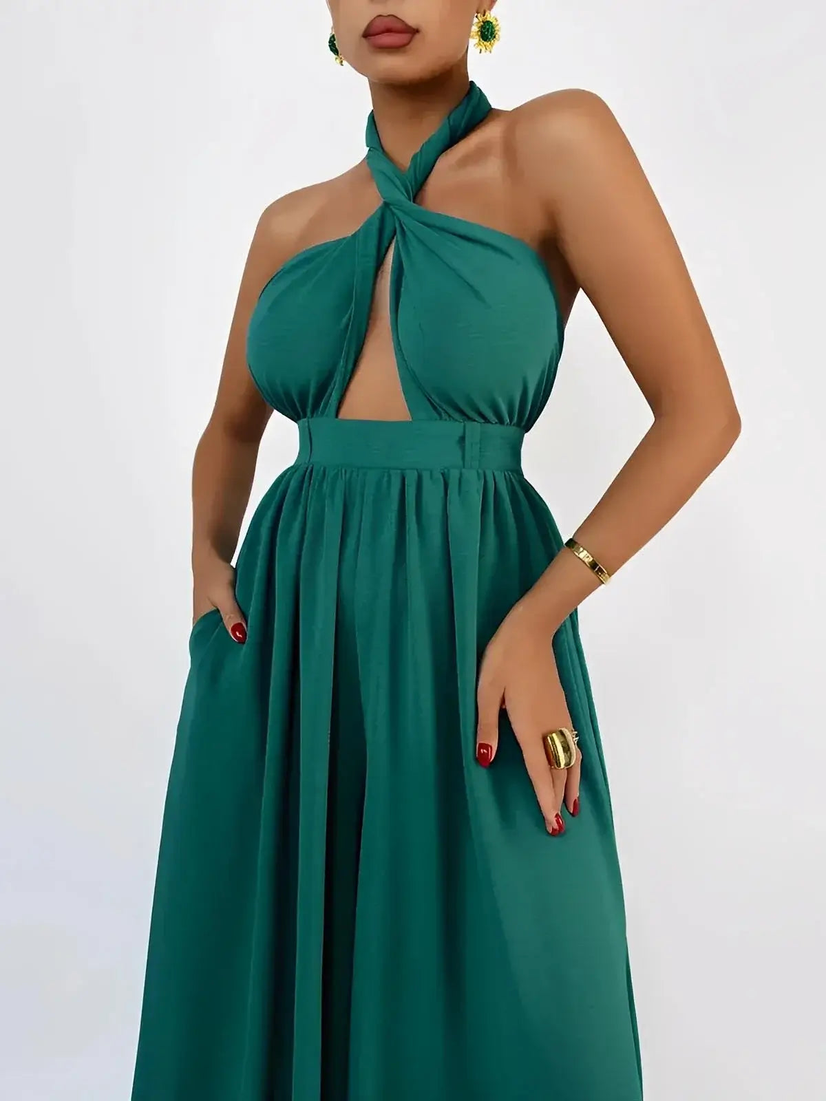 Verona Jumpsuit by Lauven in rich emerald, featuring a twisted halter neckline and open back for an elegant silhouette.