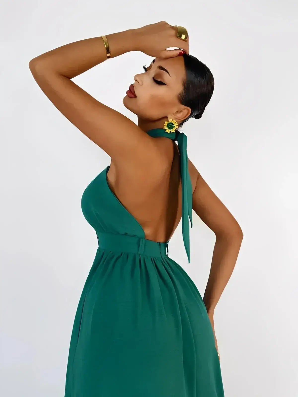Verona Jumpsuit by Lauven, showcasing a halter neck and open back design in rich emerald green.