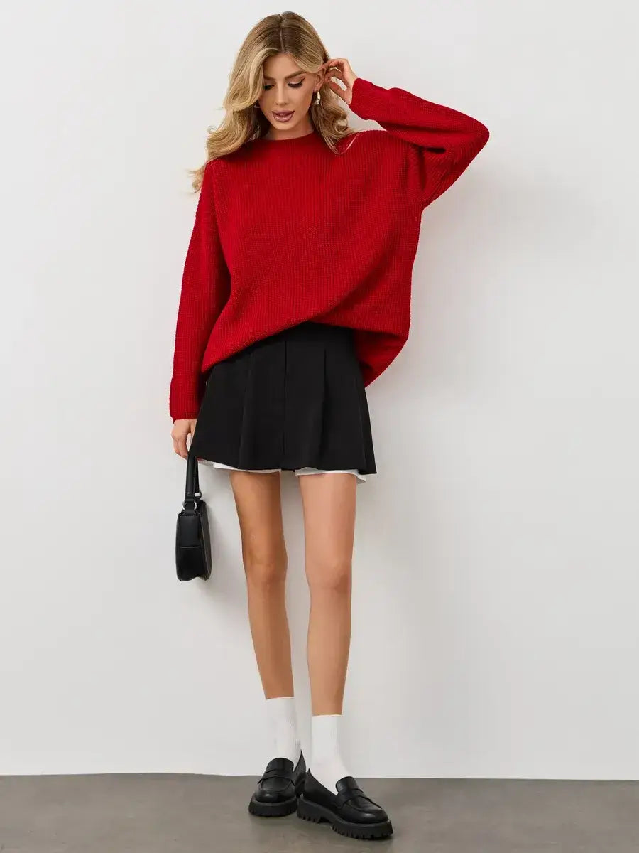 Viona Sweater by Lauven: oversized red knit pullover with crew neck, paired with a black skirt and stylish accessories.