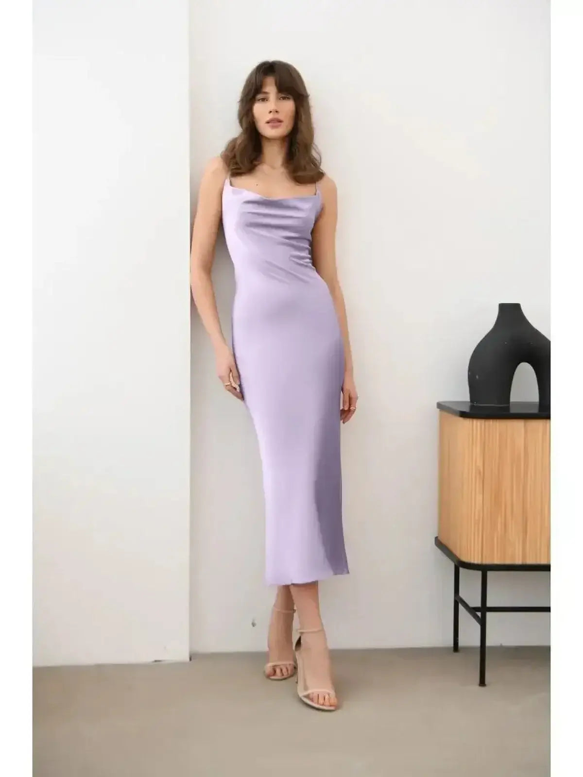 Whisper Midi Dress in lavender satin, showcasing a slip-style cut and draped neckline, perfect for elegant summer events.